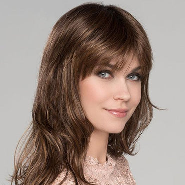 Pretty is a long, layered, and wavy wig with a full bang