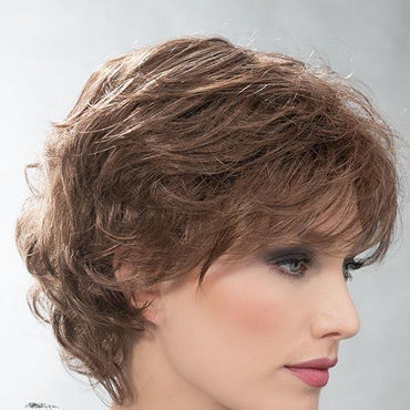 This sophisticated style features all-over layers, soft body, and curls